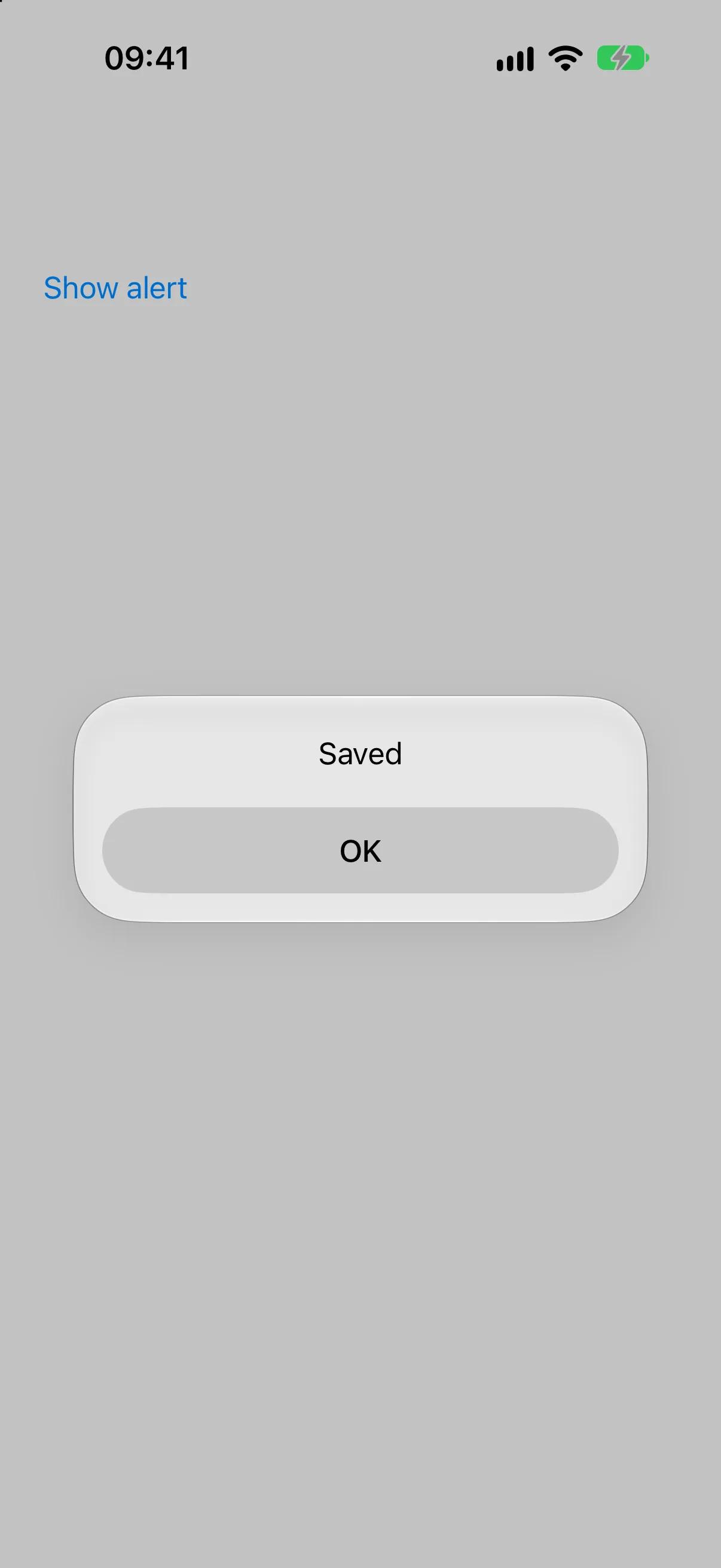 标题为 Saved、包含单个 OK 按钮的 Alert，位于 Show alert 触发器上方